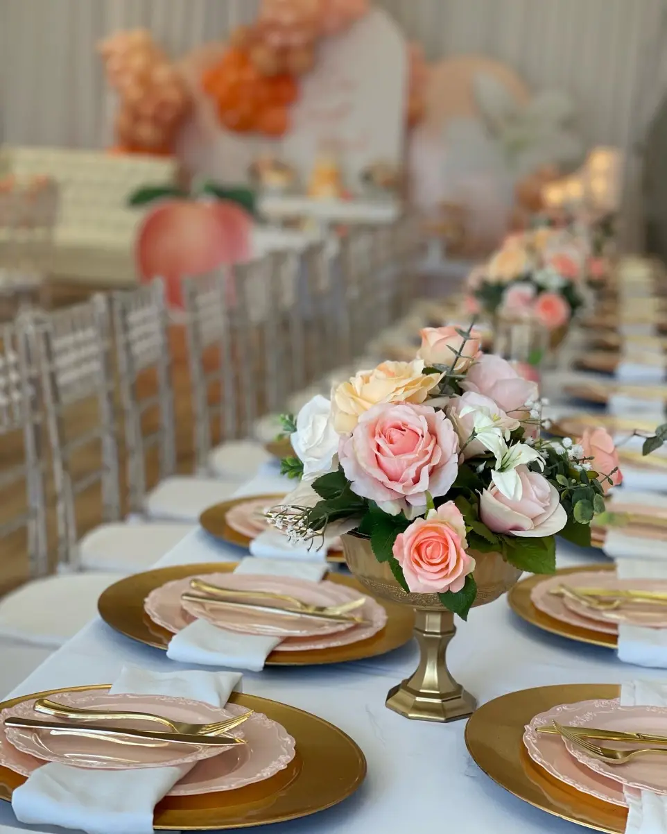 Elegant 1st birthday table with gold accents, floral centerpieces, and luxury tableware