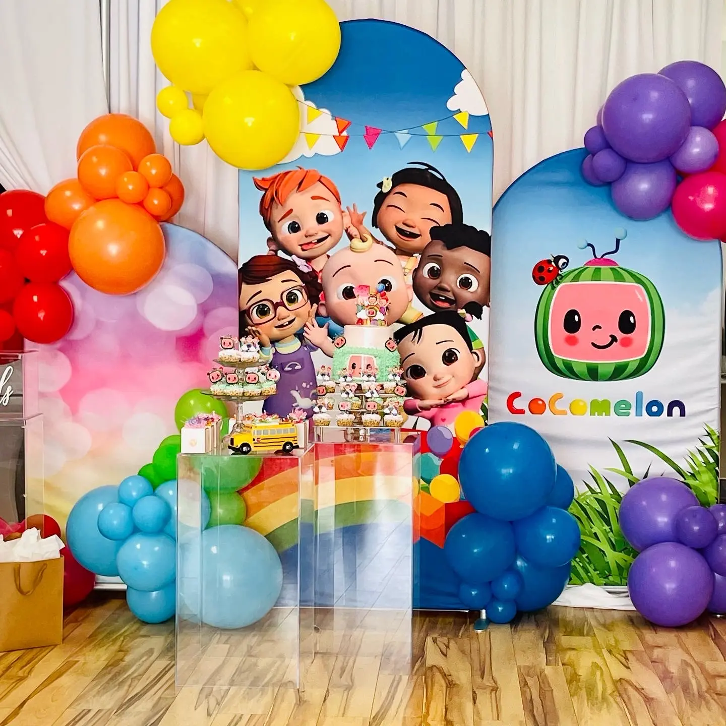 Vibrant kids’ birthday with colorful balloon wall and cartoon theme.
