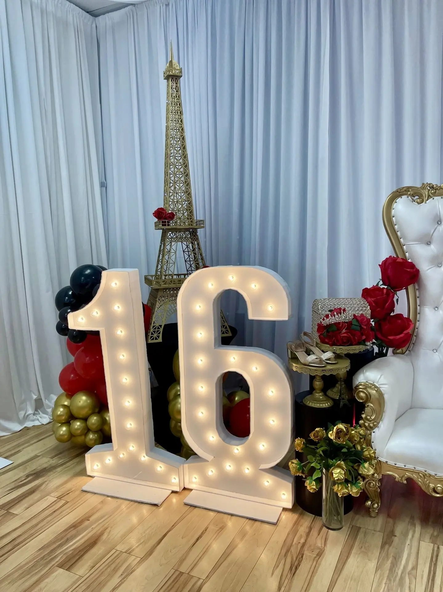 Sweet 16 celebration with elegant table décor and illuminated 16 sign marquee.