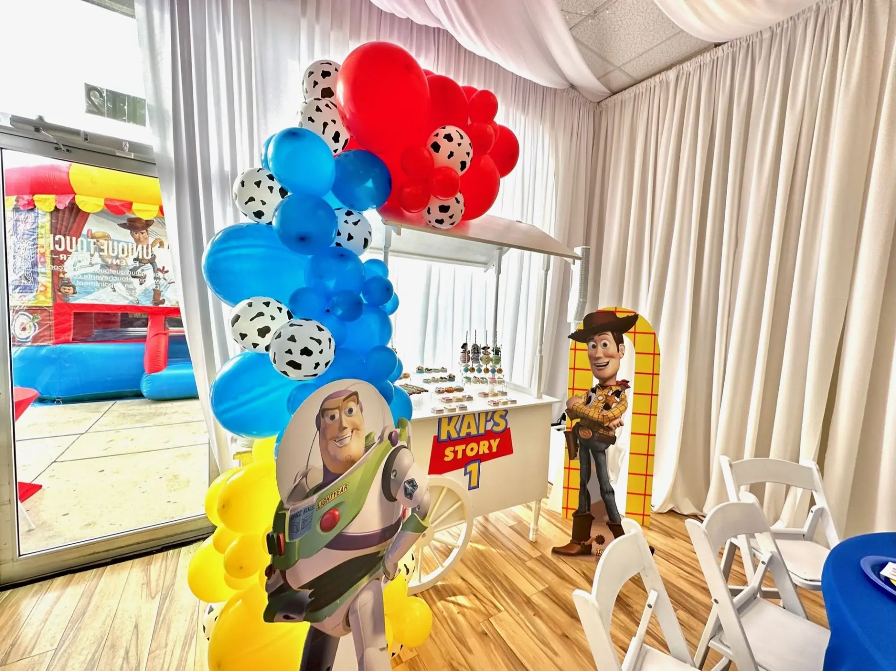Vibrant kids’ birthday with colorful balloon wall, candy cart and cartoon theme.