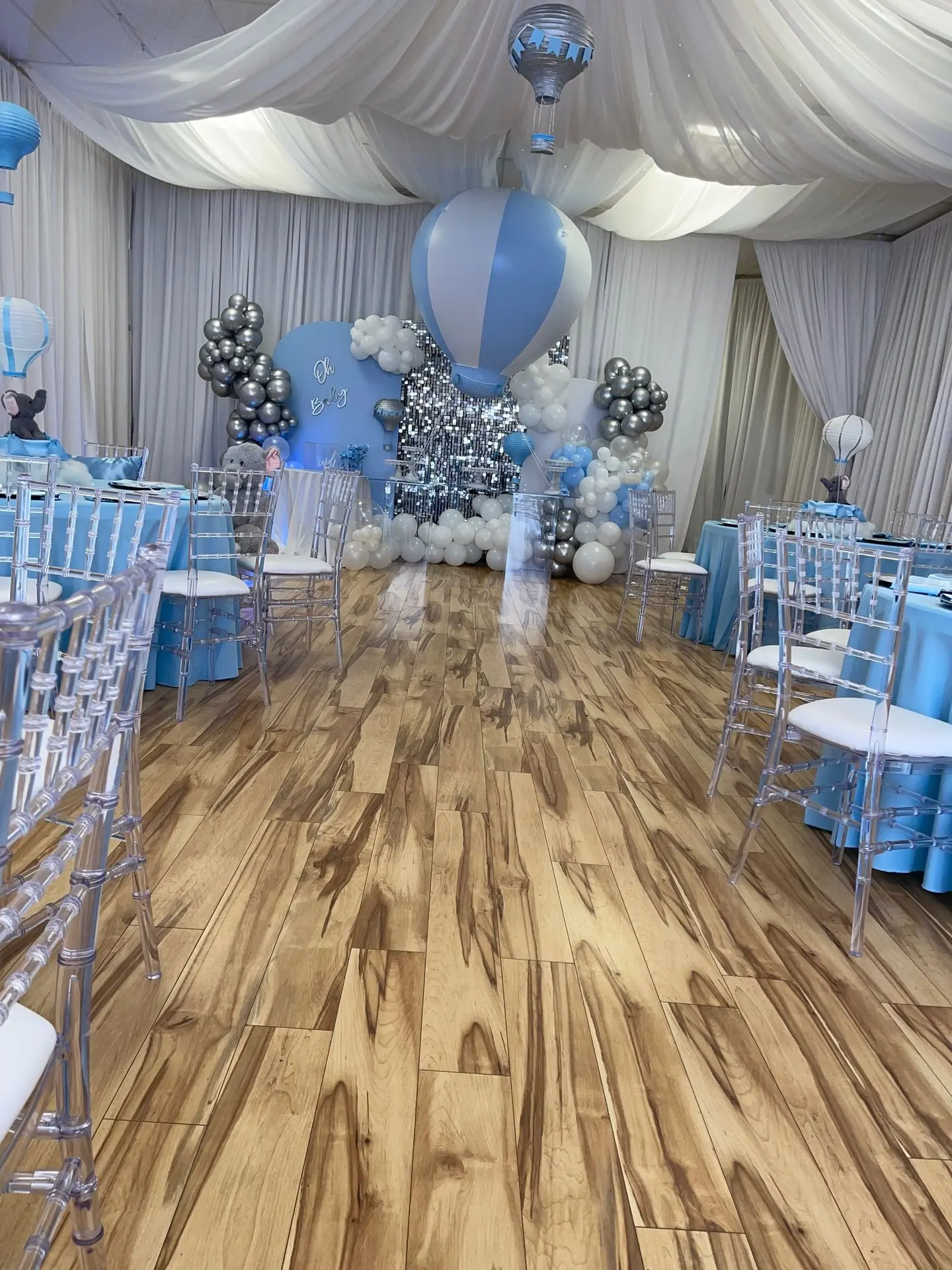 Hotair Balloons Elephant Light blue, white and  silver baby showerA wide-angle shot of your Orlando event space, showing tables, chairs, lighting, and décor in a finished setup.